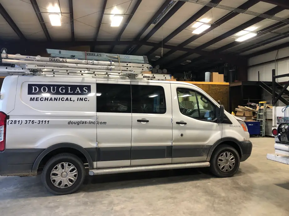 A Douglas Mechanical service van loaded and parked inside the Carrot Street shop